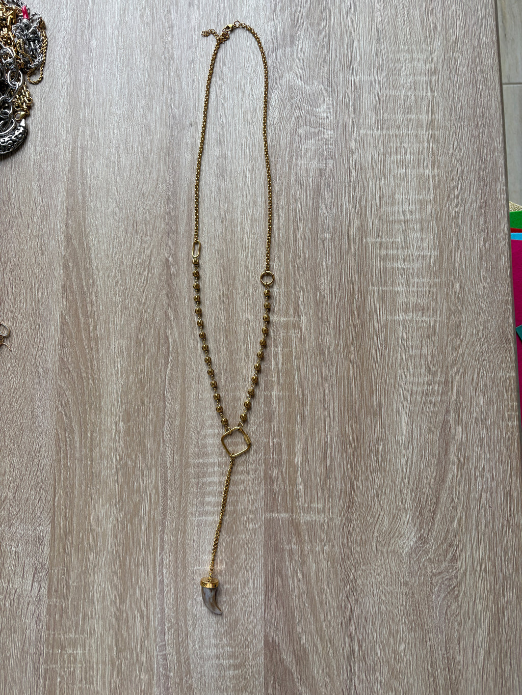 Collana corno in acciaio dorato