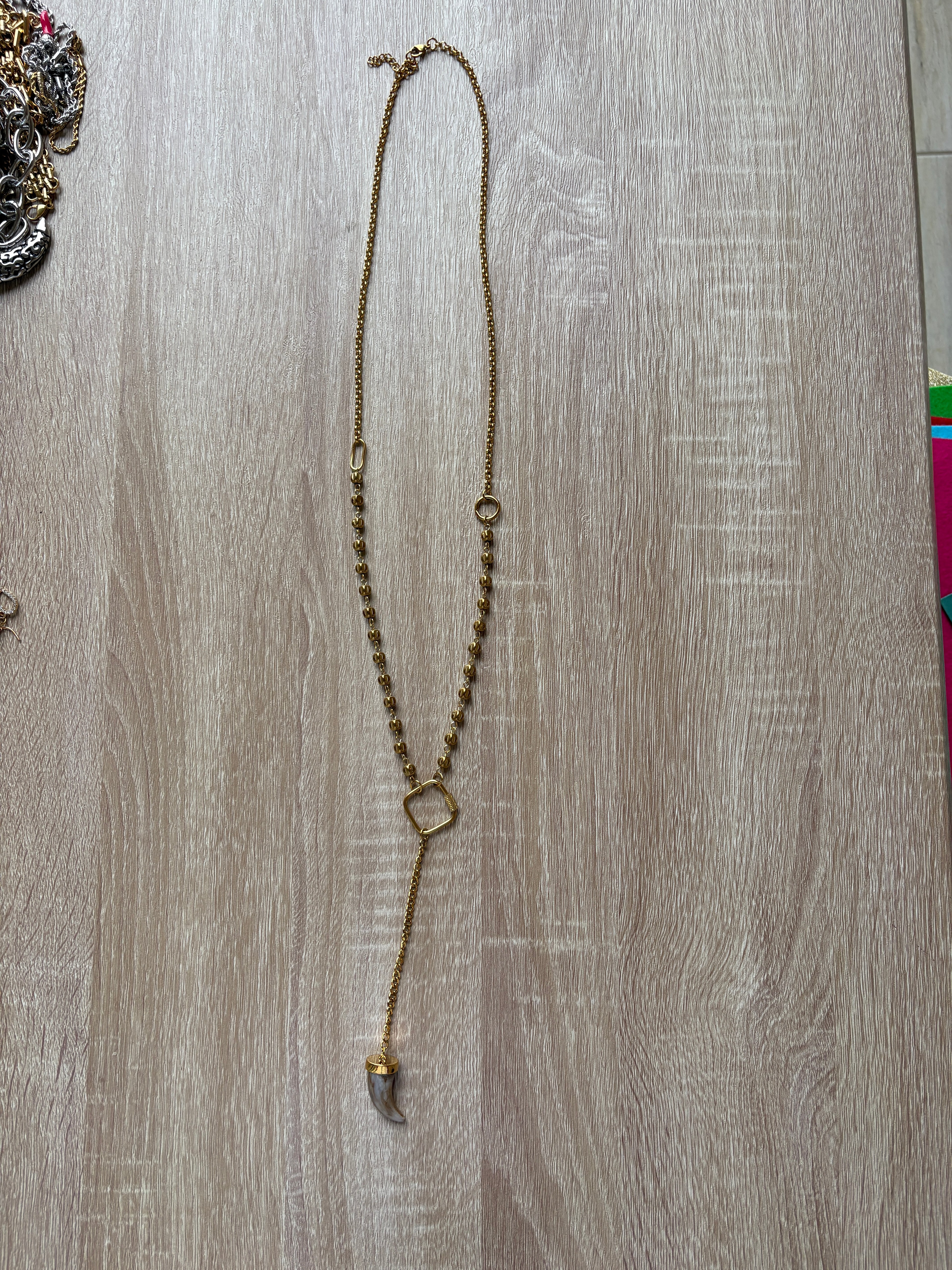 Collana corno in acciaio dorato