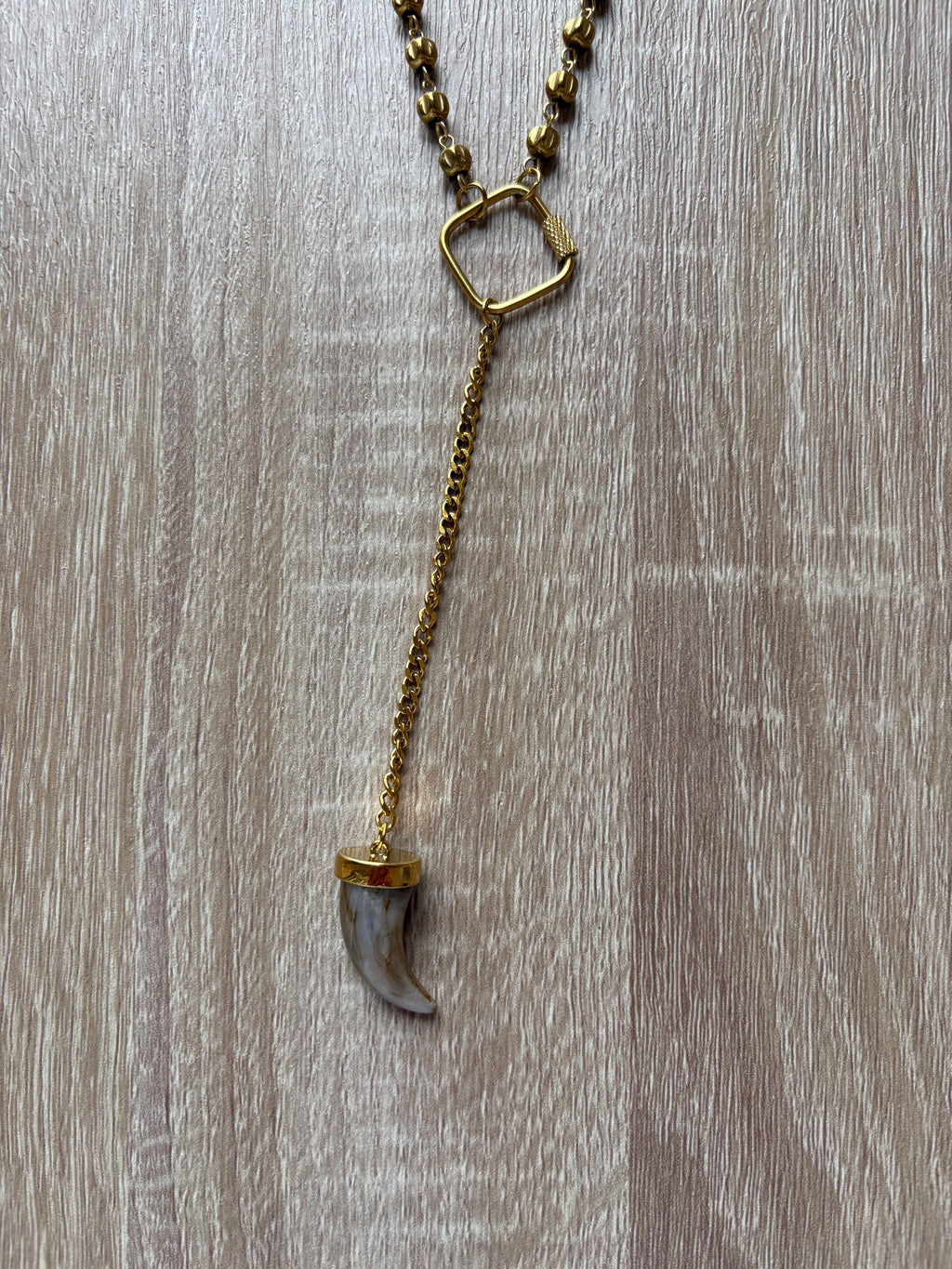 Collana corno in acciaio dorato