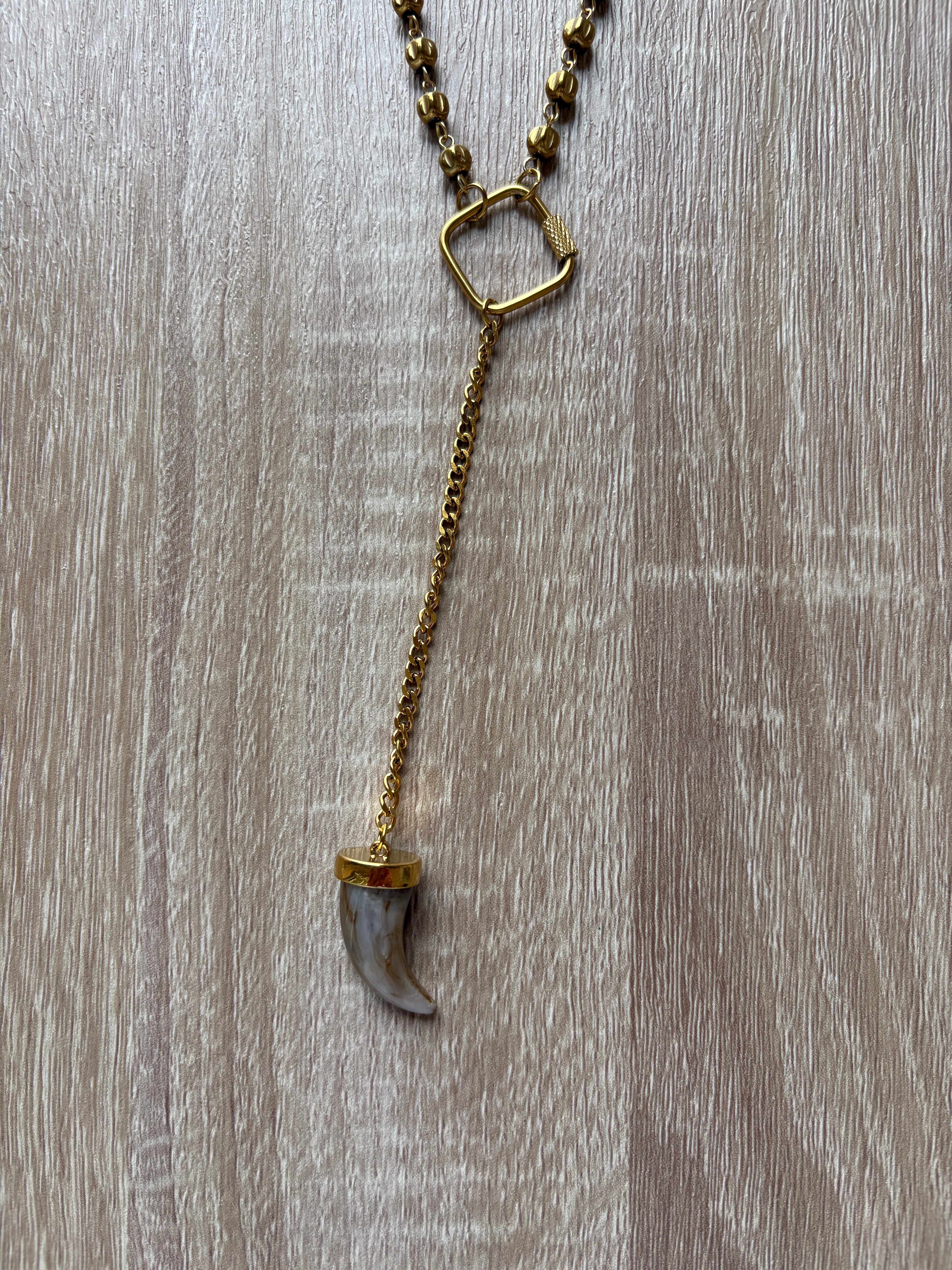 Collana corno in acciaio dorato